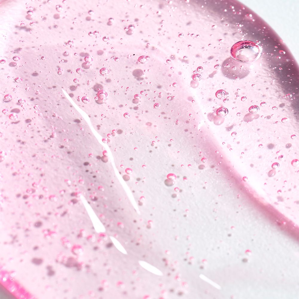 Rosa Gel-Textur mit kleinen Bläschen, Nahaufnahme.