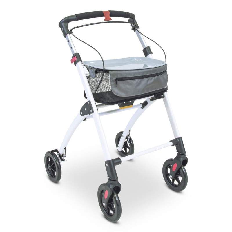 Rollator mit weißem Rahmen, schwarzem Korb und Rädern. Graue Tasche. Schwarze Griffe mit roter Bremse. Vier Räder.
