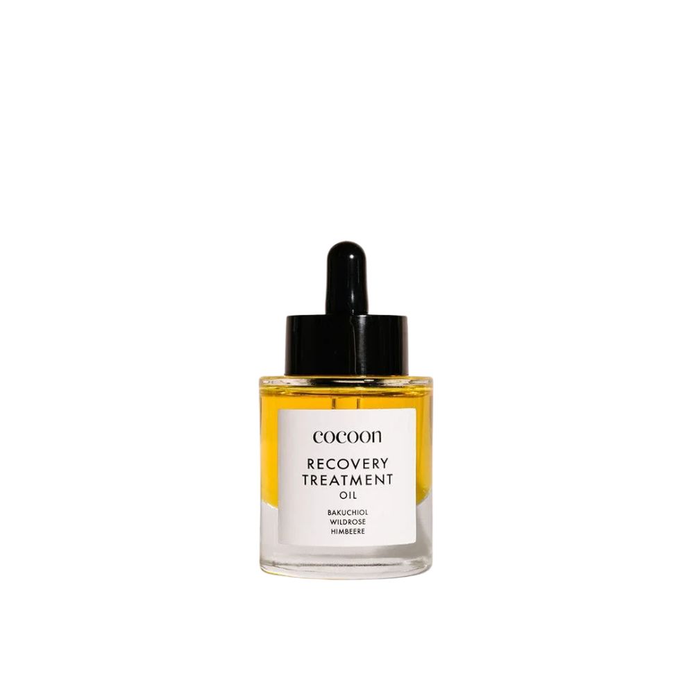 Klarflasche mit schwarzem Deckel und Pipette. Etikett mit "cocoon Recovery Treatment Oil".
