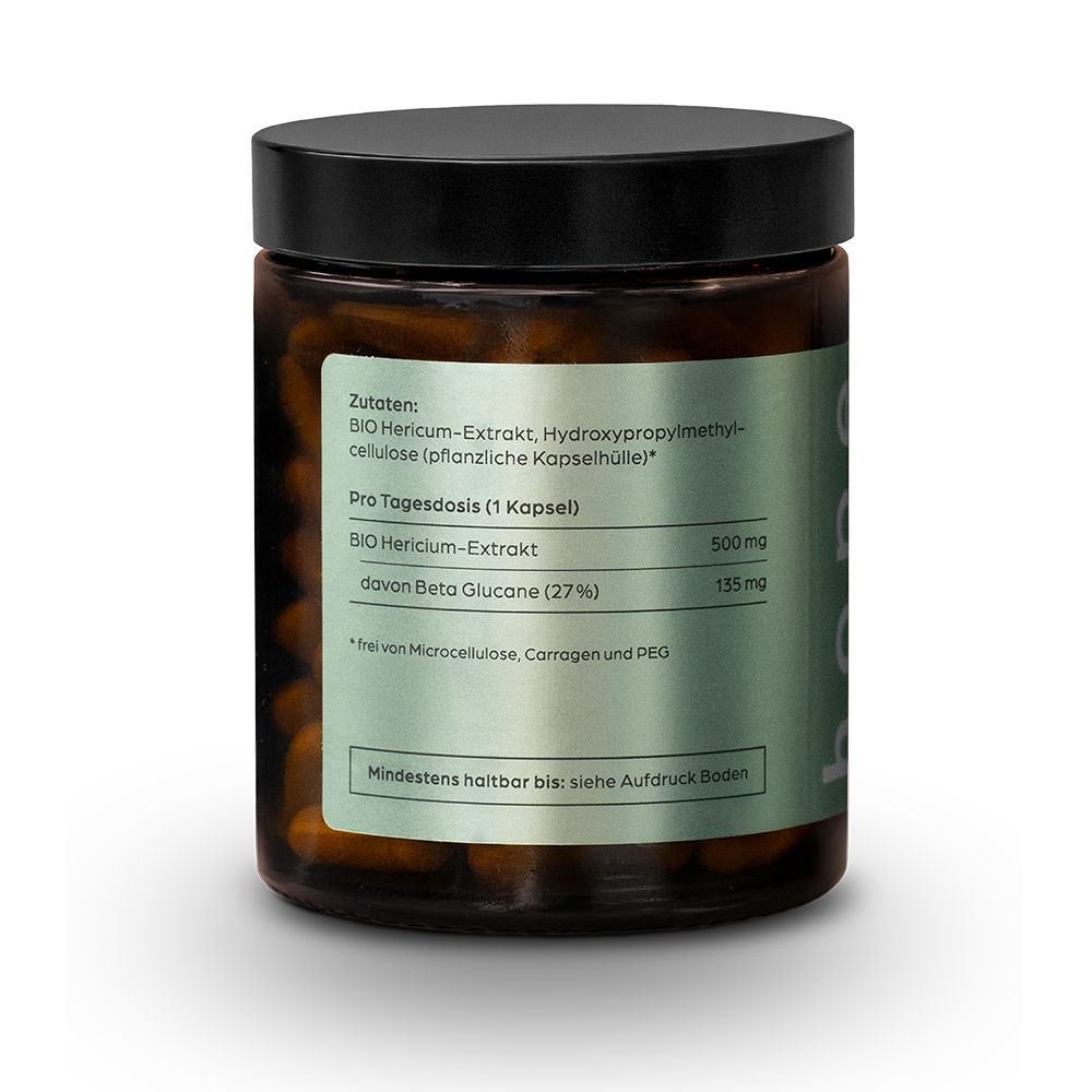 Braune Kapseln in einer braunen Glasdose mit schwarzem Deckel. Aufschrift auf dem Etikett.