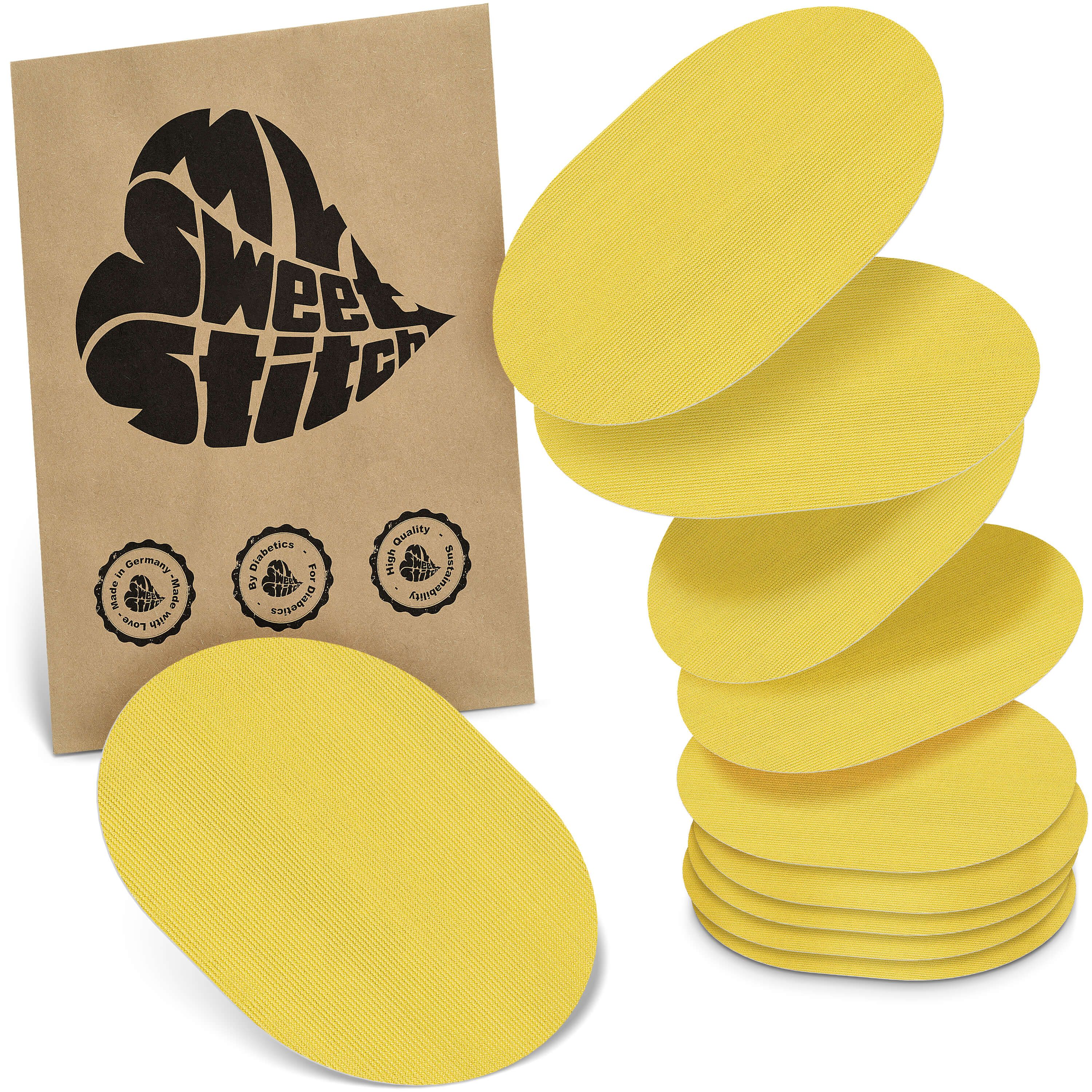 Gelbe, ovale Pflaster. Verpackung mit Logo und Qualitätssiegeln. Stapel von Pflastern neben der Verpackung.