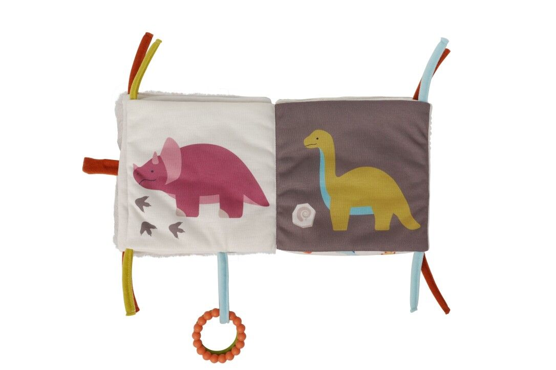 Offenes Stoffbuch mit Dino-Motiven. Rosa Triceratops und gelber Dino. Bunte Bänder und Ringe zum Greifen.