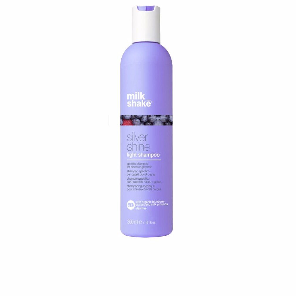 Shampoo-Flasche. Lila Flasche mit weißem Deckel. Aufschrift: Milk Shake, Silver Shine Light Shampoo. Mit Blaubeere.