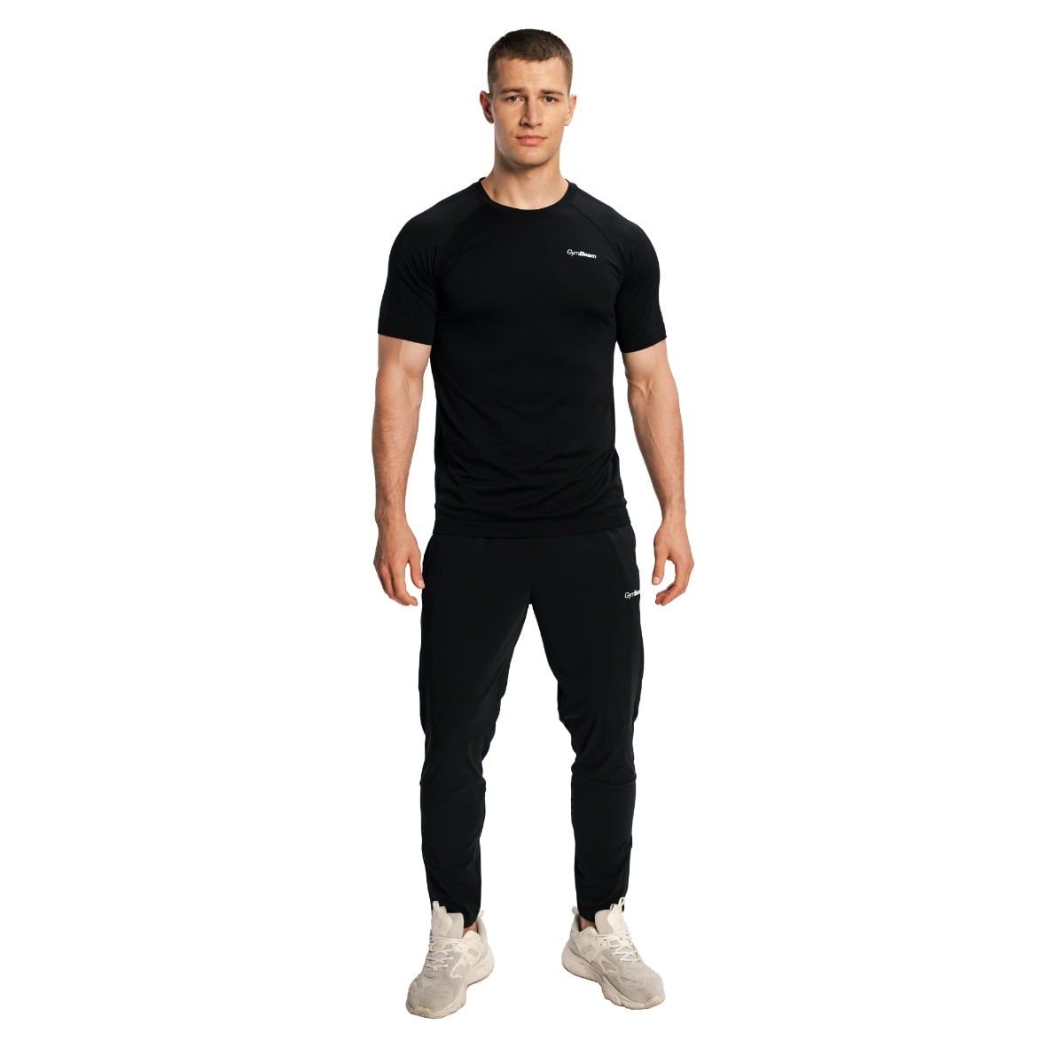 Mann in schwarzer Jogginghose und schwarzem T-Shirt, Vorderansicht.