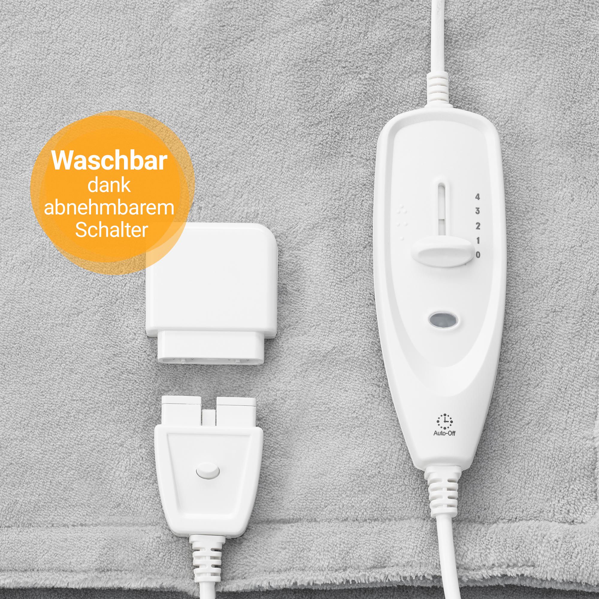 Nahaufnahme des abnehmbaren Bedienelements und Steckverbinders einer grauen Heizdecke.