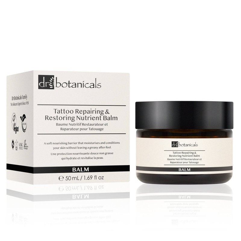 Dr. Botanicals Tattoo-Balsam in Braunglasflasche mit schwarzem Deckel und Umverpackung.