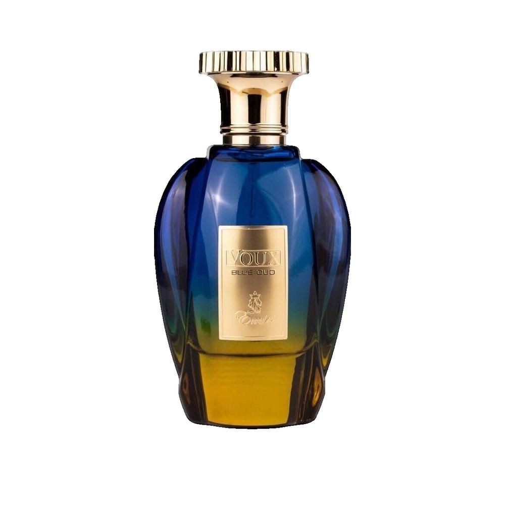 Blau-gelbe Parfumflasche mit goldfarbenem Verschluss. Aufschrift: Voux Blue Oud. Flakon mit goldfarbenem Detail.