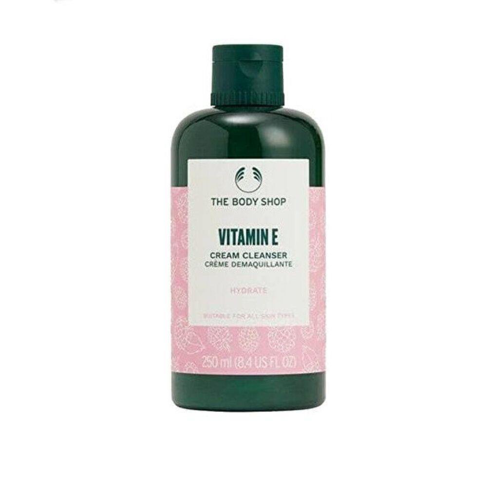 Grüne Flasche mit weißem Etikett. Aufschrift: Vitamin E Cream Cleanser. Marke: The Body Shop. Inhalt: 250 ml.