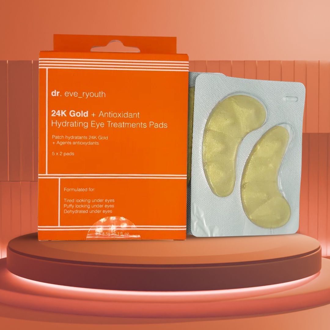 Orangefarbene Schachtel und goldene Augenpads in einer Packung. Auf der Schachtel steht "dr. eve_ryouth 24K Gold + Antioxidant Hydrating Eye Treatments Pads".