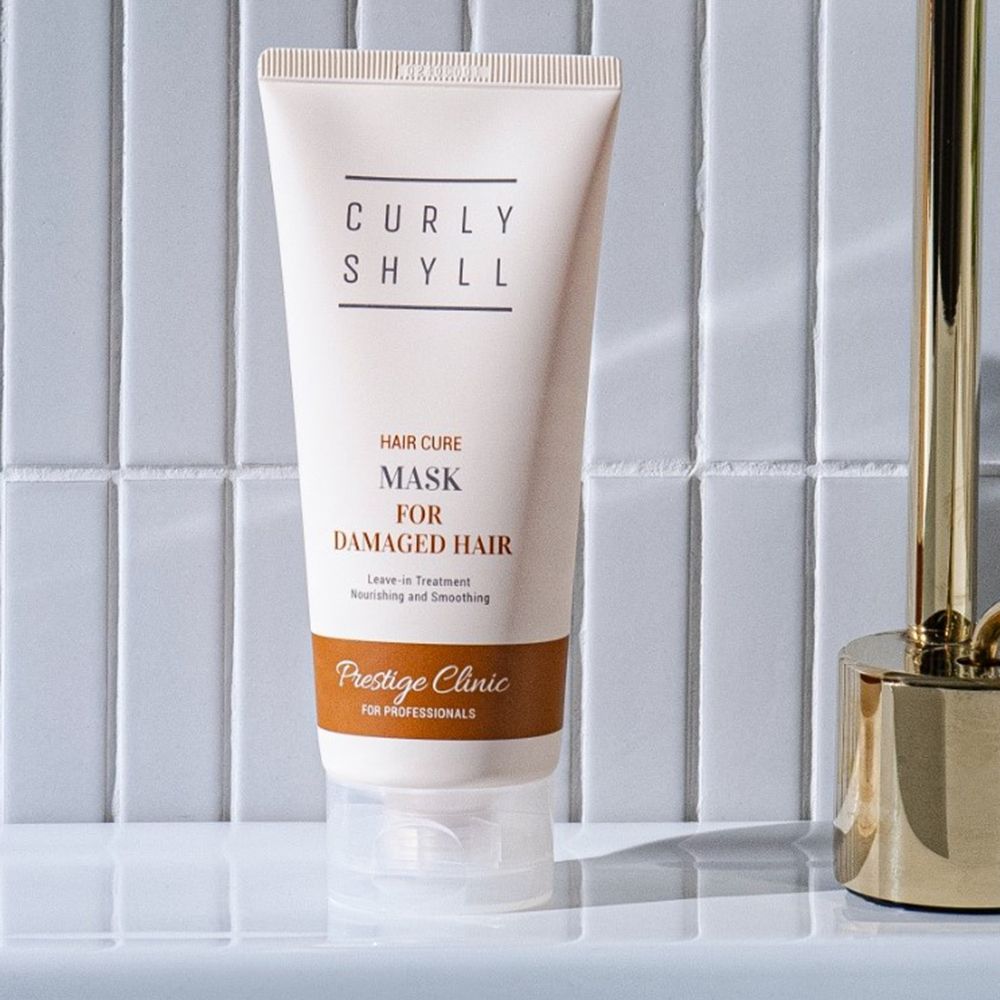 Tube mit CURLY SHYLL, Hair Cure Mask for Damaged Hair. Leave-in Treatment. Prestige Clinic. Auf weißem Untergrund.