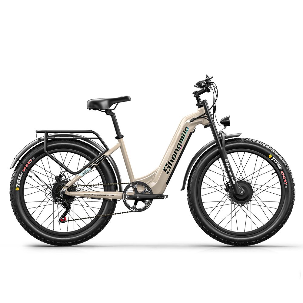 E-Bike, Seitenansicht. Beige Rahmen, schwarze Reifen. Marke Shengmilo sichtbar. Gepäckträger und Schutzbleche.