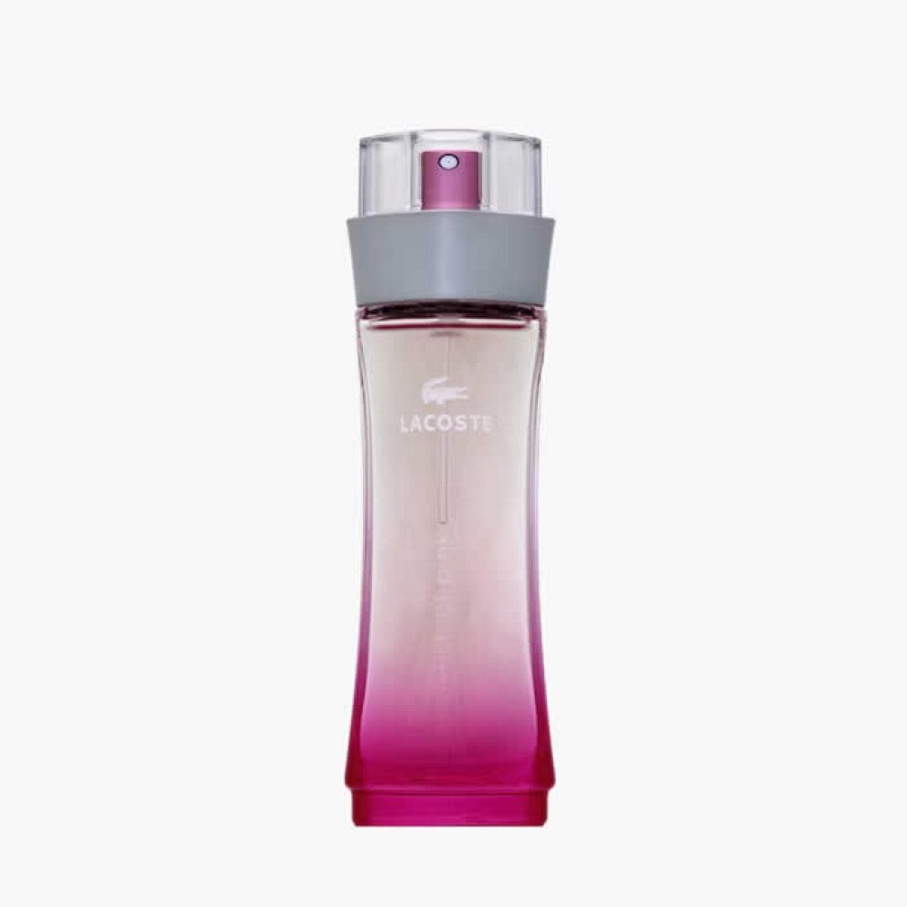 Lacoste Touch of Pink Eau de Toilette Flakon. Rosa Farbverlauf, grauer Ring, transparenter Sprühkopf.
