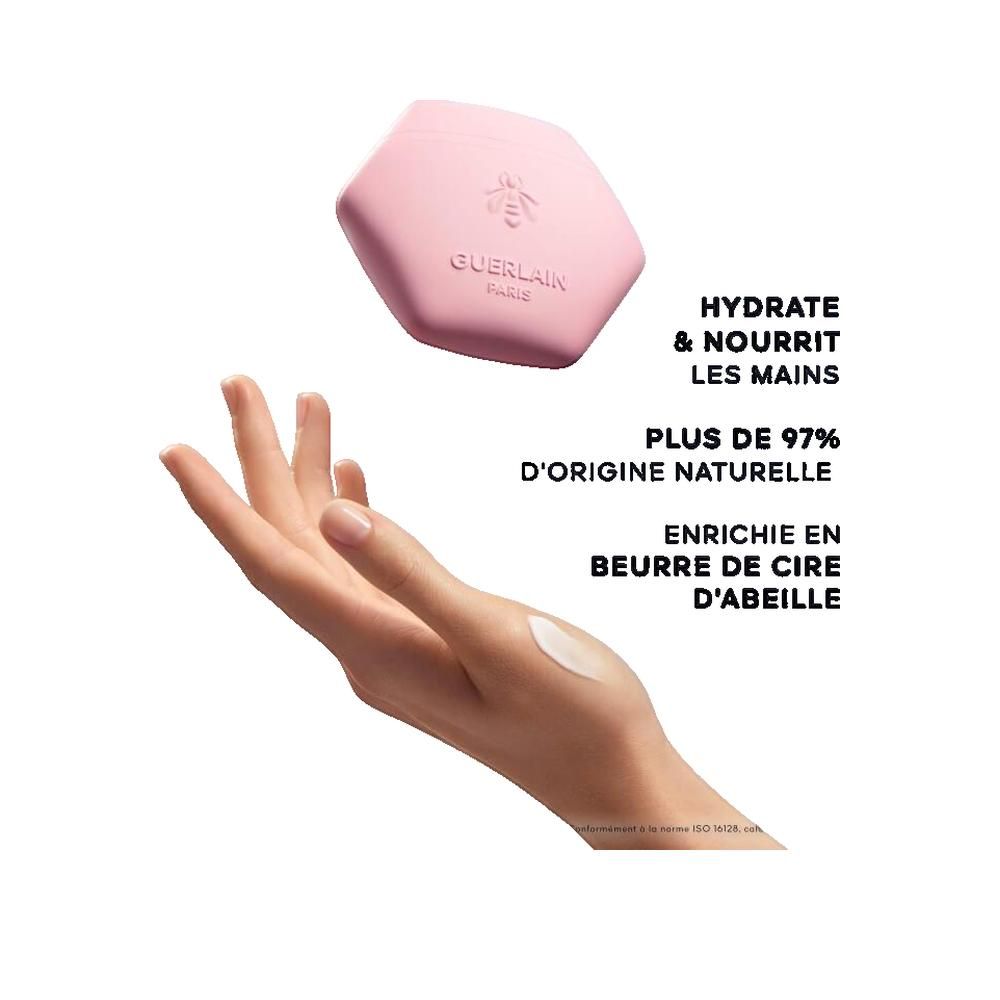 Rosa Rossa Handcreme-Behälter, rosa, sechseckig, mit Biene und Schriftzug Guerlain. Hand mit Creme.