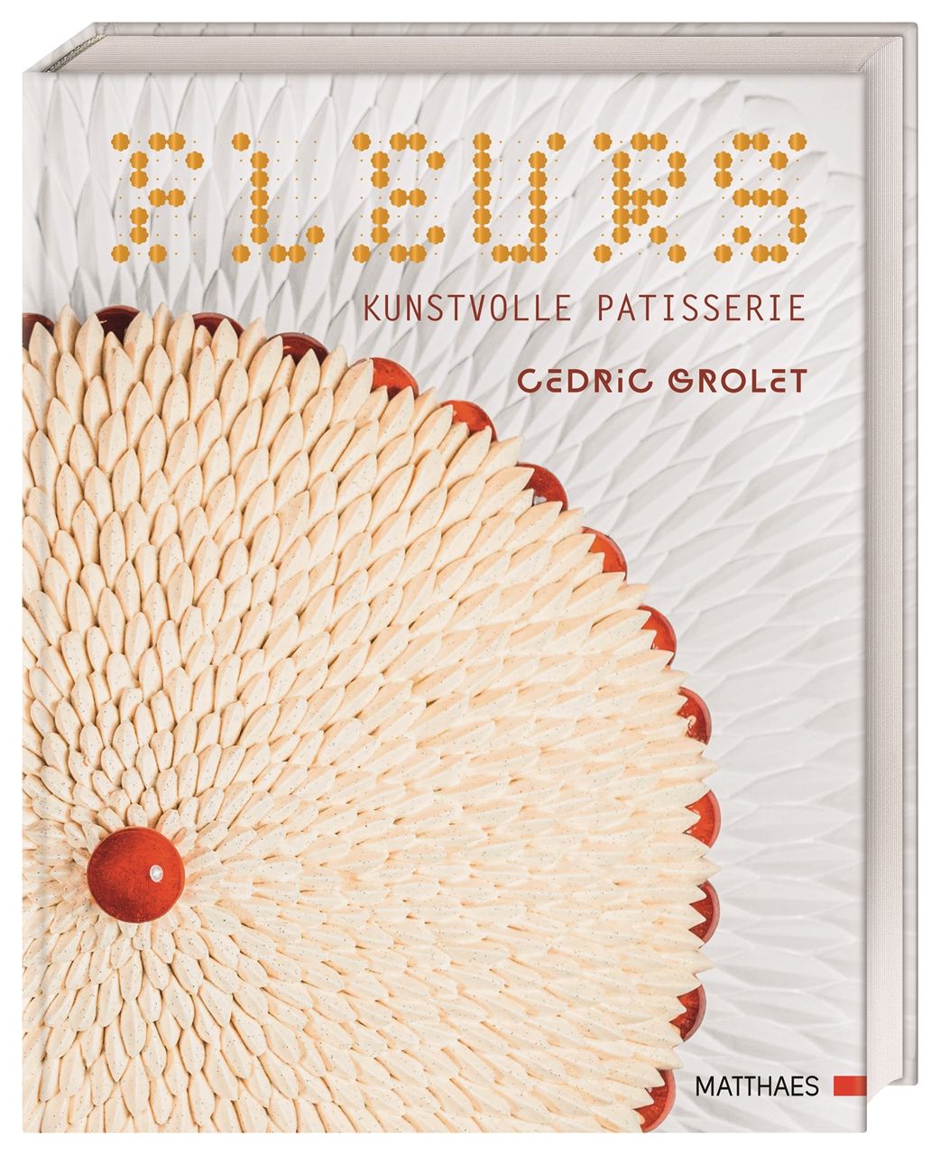 Buchcover mit Titel "FLEURS" und Untertitel "KUNSTVOLLE PATISSERIE". Autor: Cédric Grolet. Gezeigt wird ein Gebäck-Dekor.