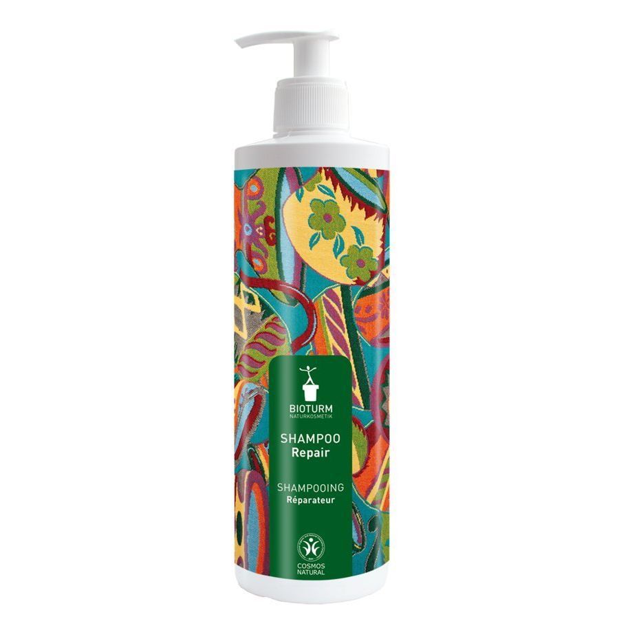 Weiße Flasche mit Pumpe. Bunte Muster. Aufschrift: Bioturm Naturkosmetik Shampoo Repair. Grünes Logo mit Pflanze.