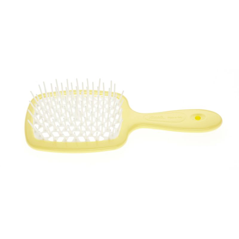 Gelbe Haarbürste mit weißem Borstenfeld und Griff. Rechteckiger Bürstenkopf mit abgerundeten Ecken. Griff mit Loch.