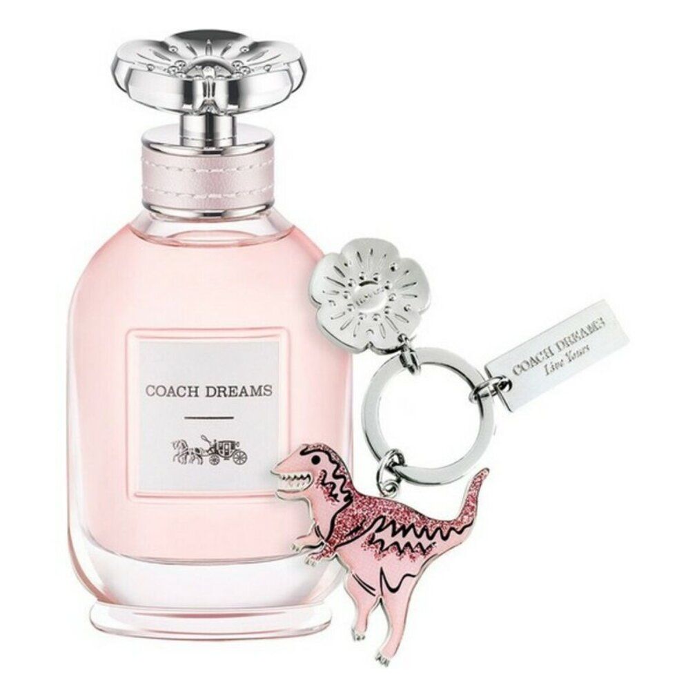Rosa Glasflasche mit silbernem Verschluss und Anhänger. Auf dem Etikett steht "COACH DREAMS" und ein Kutschen-Logo.