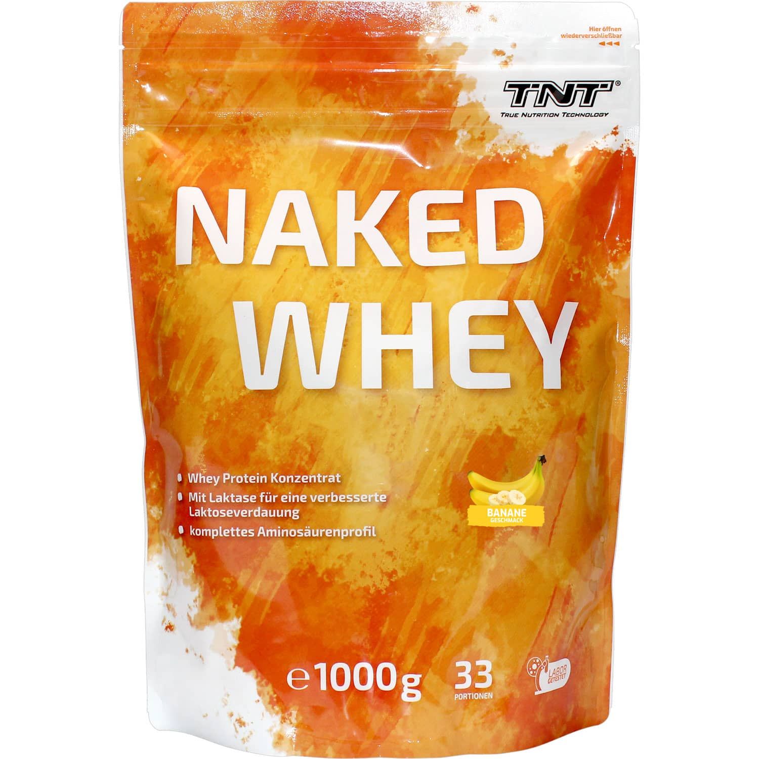Beutel TNT Naked Whey. Aufschrift: Naked Whey, Molkenproteinkonzentrat, Banane. Mit Laktase für verbesserte Laktoseverdauung.