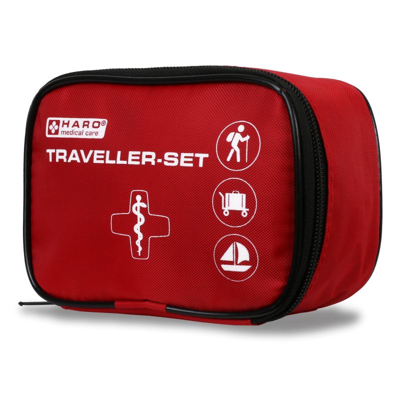 Rote Erste-Hilfe-Tasche mit schwarzem Reißverschluss und Logo. Aufschrift: HARO medical care, TRAVELLER-SET. Symbole: Wanderer, Koffer, Segelboot.
