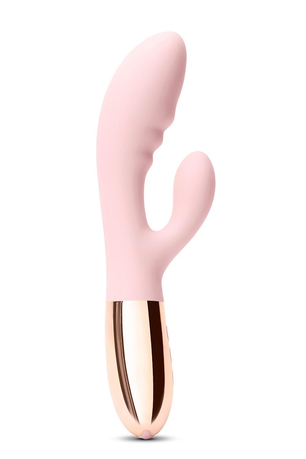 Rosa Vibrator mit goldfarbenem Sockel. Drei Knöpfe.  Der obere Teil hat eine gebogene Form.
