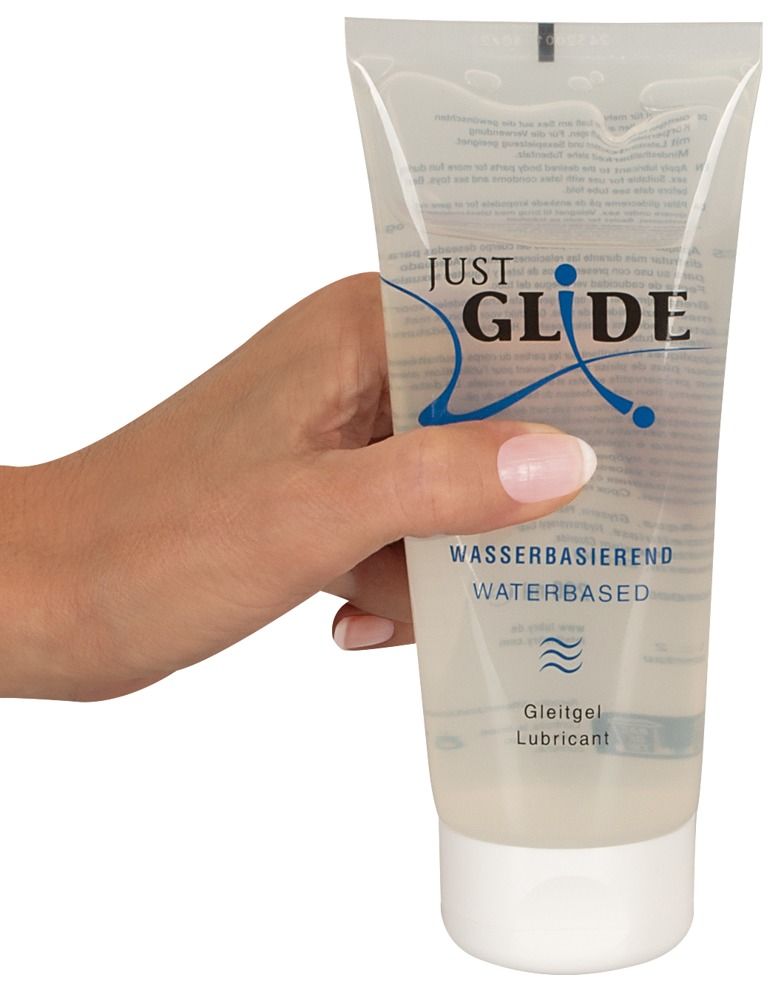 Hand hält Tube. Aufschrift: JUST GLIDE, wasserbasiert, Gleitgel.