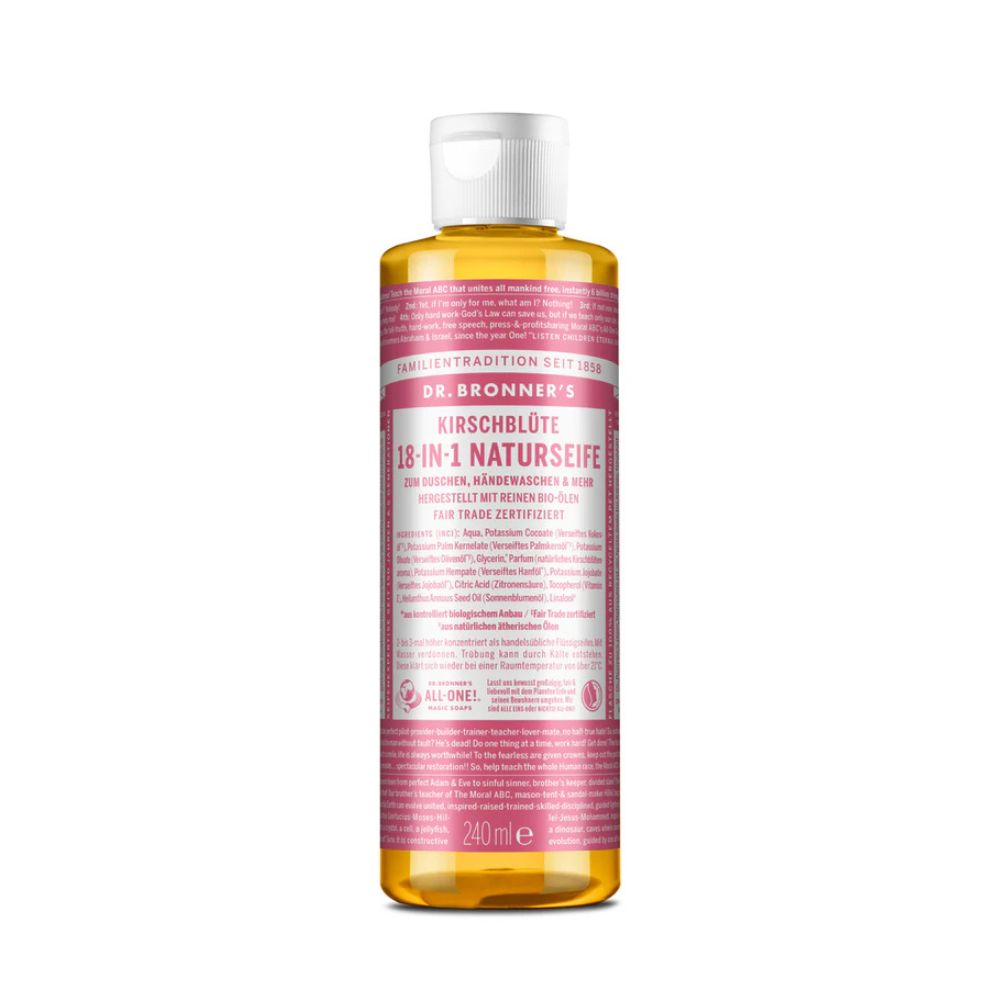 Eine Flasche Dr. Bronner's 18-in-1 Naturseife Kirschblüte. Rosa Etikett mit Produktinformationen. Transparente, gelbliche Flüssigkeit.