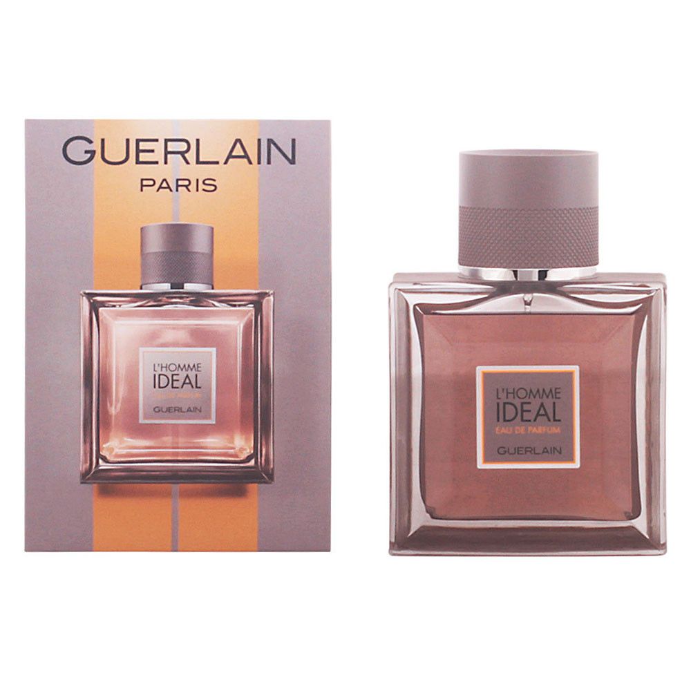 Flakon und Verpackung von Guerlain L'Homme Ideal Eau de Parfum. Quadratischer Flakon, hellbraune Flüssigkeit, grauer Deckel. Verpackung mit Logo.
