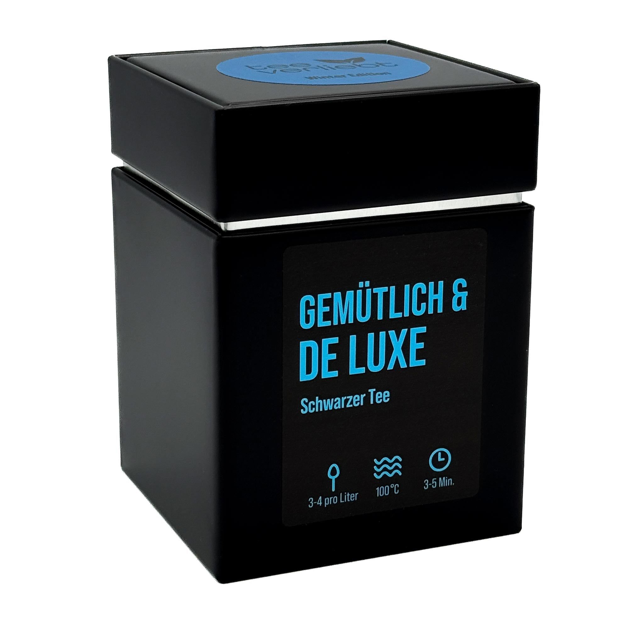 Schwarze Geschenkdose mit blauem Deckel. Aufschrift: Gemütlich & De Luxe, Schwarzer Tee. Mit Zubereitungshinweisen.