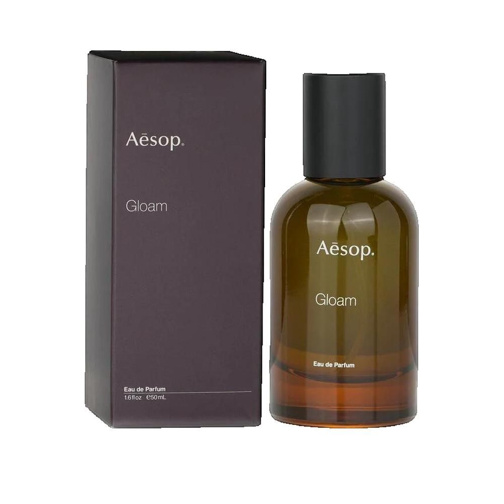 Braune Glasflasche mit schwarzem Deckel und Verpackung. Klarin-Logo und Gloam-Schriftzug.