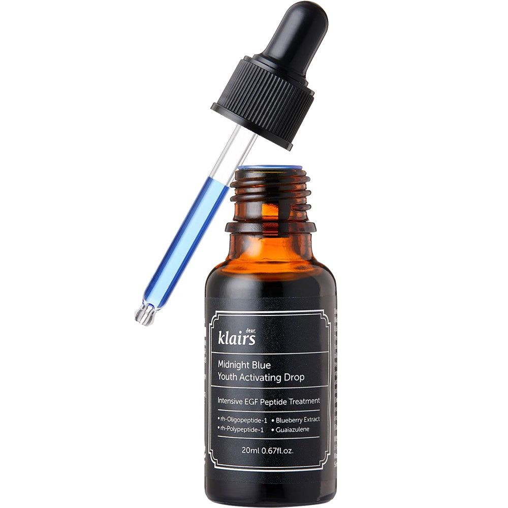 Braune Glasflasche mit schwarzem Deckel und Pipette. Auf dem Etikett steht "Midnight Blue Youth Activating Drop".