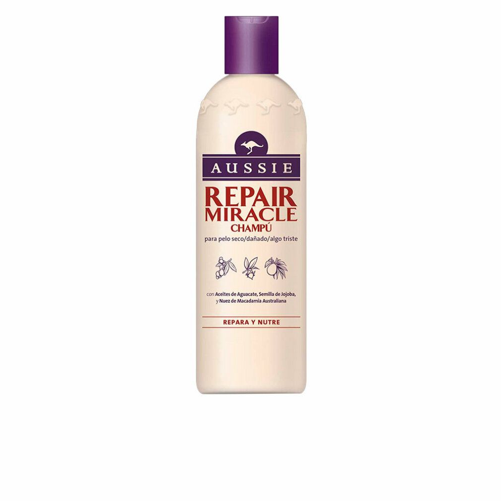 Beige Shampoo-Flasche mit lila Deckel. Aufschrift: Aussie Repair Miracle Champú. Mit Känguru-Logo.