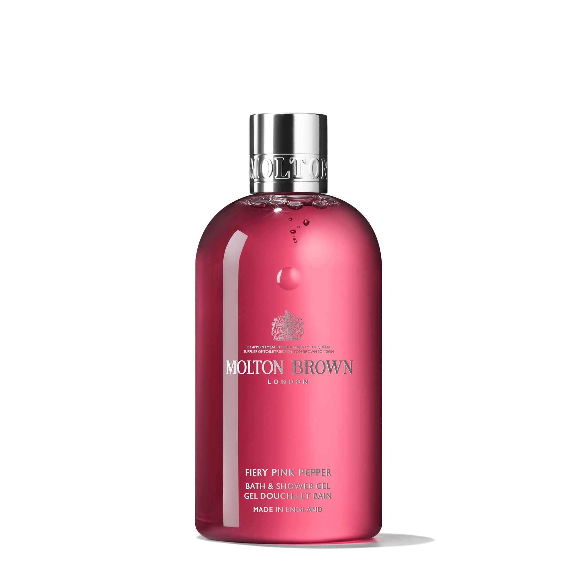 Molton Brown Duschgel in Pink Pepper, klare rosa Flüssigkeit in einer transparenten Flasche mit silbernem Verschluss.