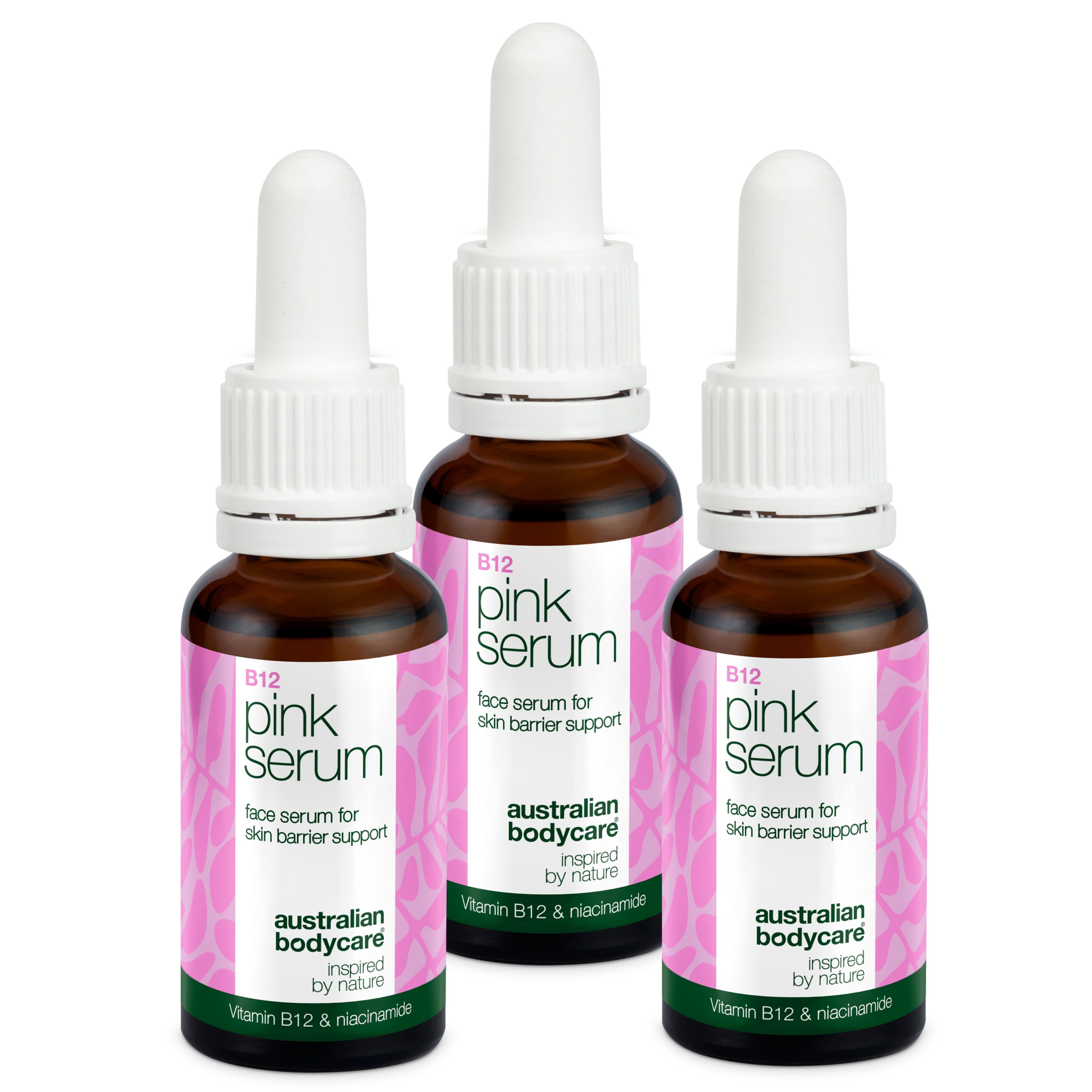 Drei Flaschen Serum. Braune Glasflaschen mit weißem Deckel. Rosa Etikett mit Text.