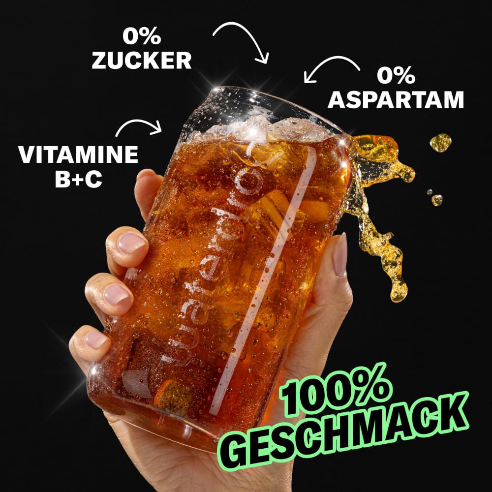 Glas mit Cola-Getränk, spritzend. Aufschrift: 0% Zucker, 0% Aspartam, Vitamine B+C, 100% Geschmack.