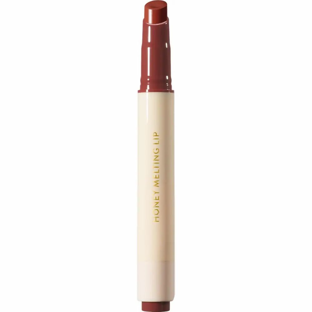 Pflegender Lipgloss in Stiftform. Weißer Stift mit braunem Lipgloss. Aufschrift: HONEY MELTING LIP.
