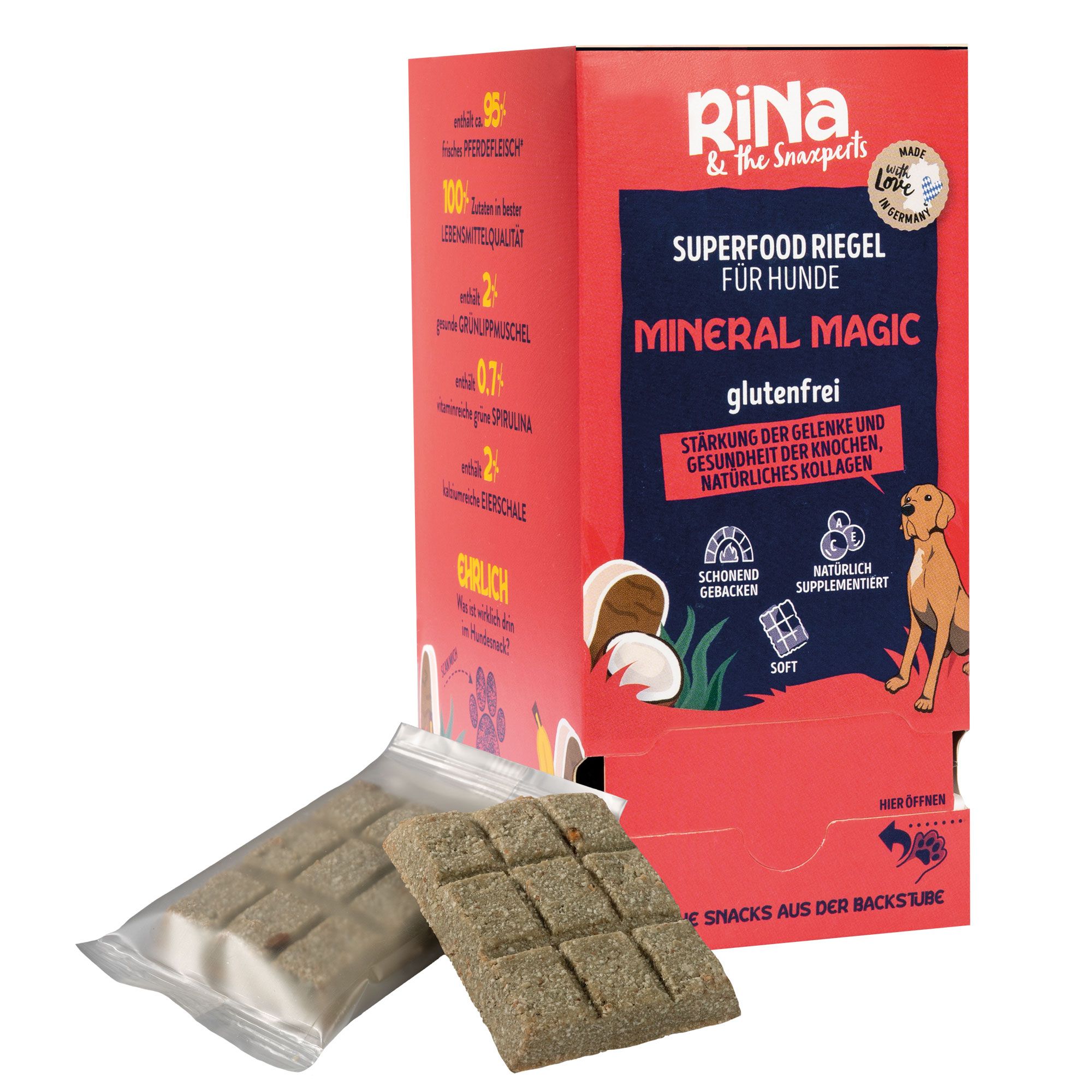 Verpackung mit Hundesnacks. Riegel in Folie und offen. Aufschrift: RiNa, Superfood Riegel, Mineral Magic, glutenfrei. Rote und weiße Verpackung.