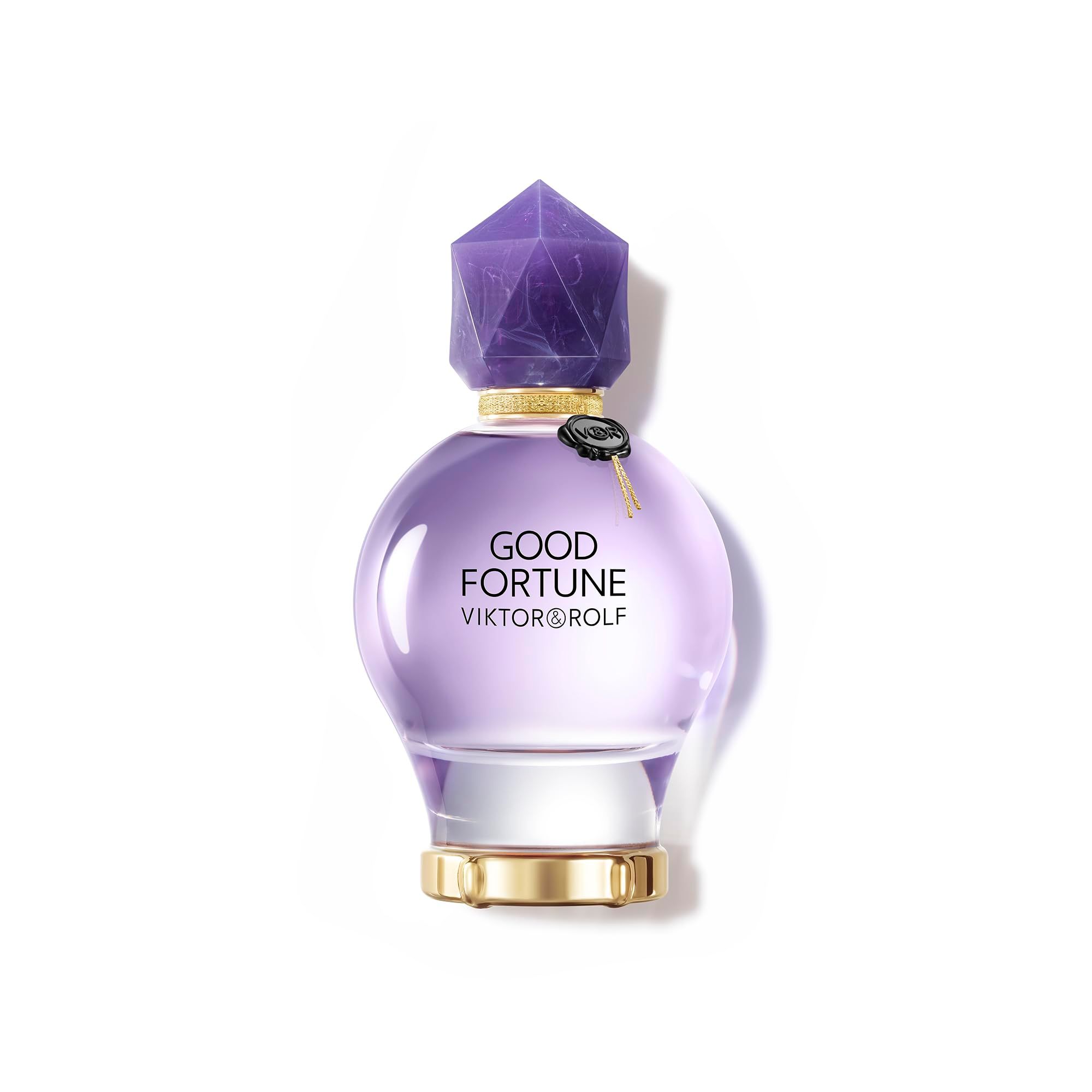 Runder, violetter Flakon mit Kristallverschluss. Goldener Ring am Boden und Hals. Aufschrift: Good Fortune, Viktor & Rolf.