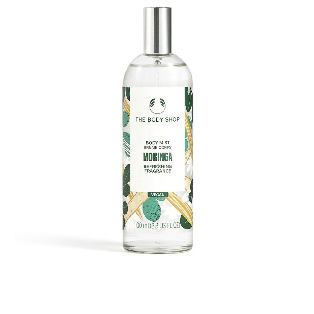 Körpernebel-Flasche mit Sprühkopf. Aufschrift: Moringa, The Body Shop. Grüne und gelbe Verzierungen.