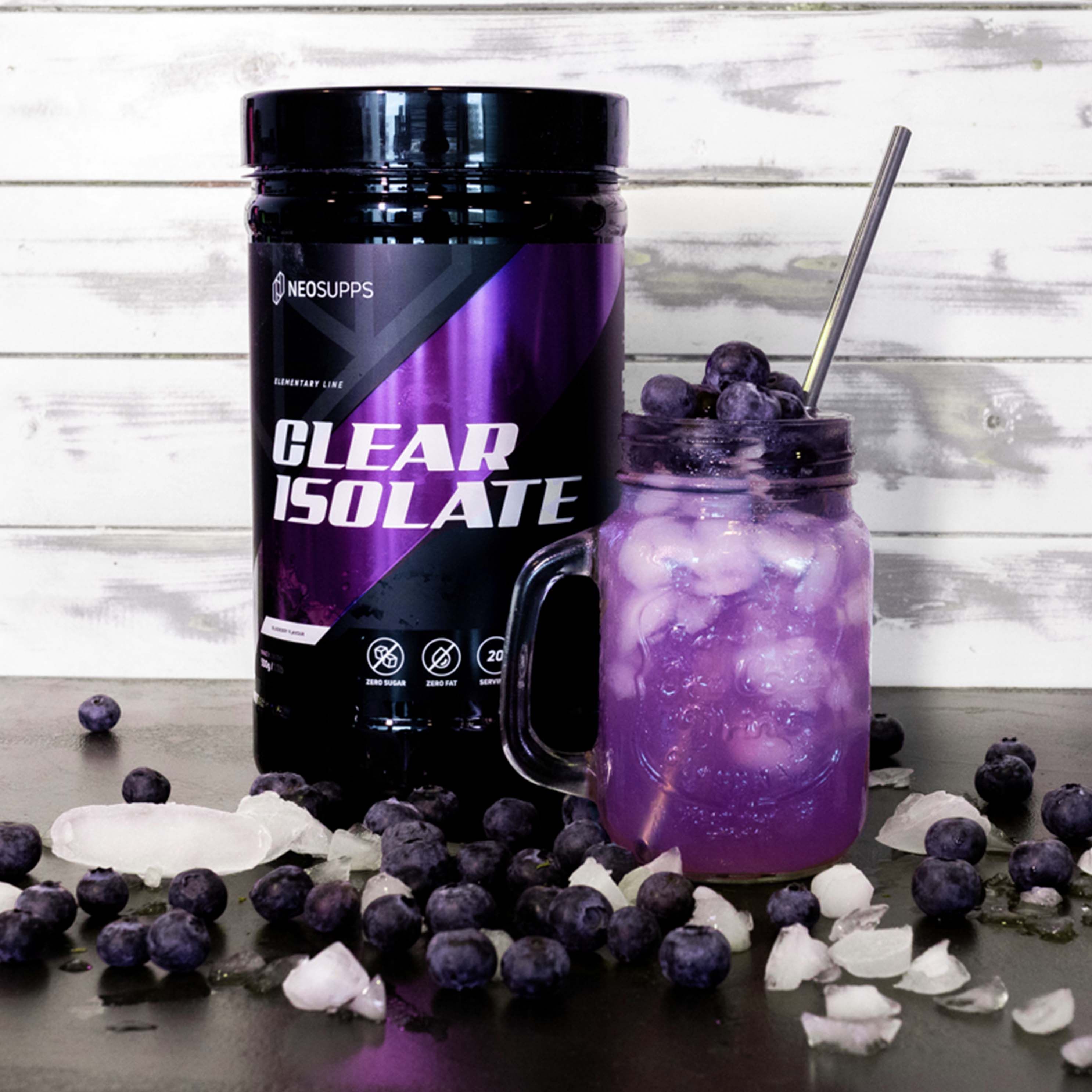 Schwarze Dose mit lila Akzenten. Aufschrift: CLEAR ISOLATE. Glas mit lila Flüssigkeit, Eiswürfeln und Blaubeeren.