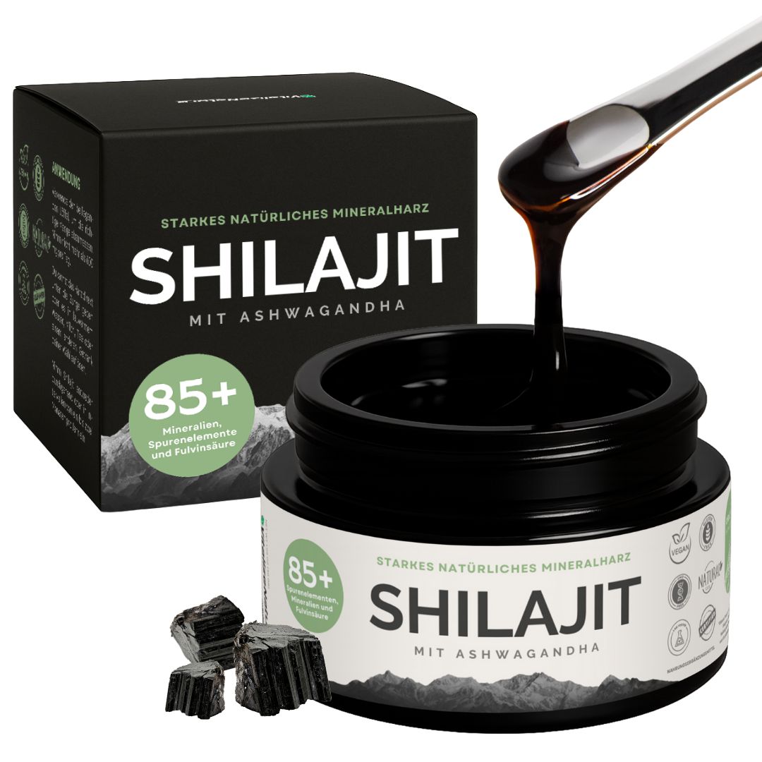 Glas mit Shilajit mit Ashwagandha und Box. Schwarze Flüssigkeit fließt aus dem Glas. 85+ Mineralien.
