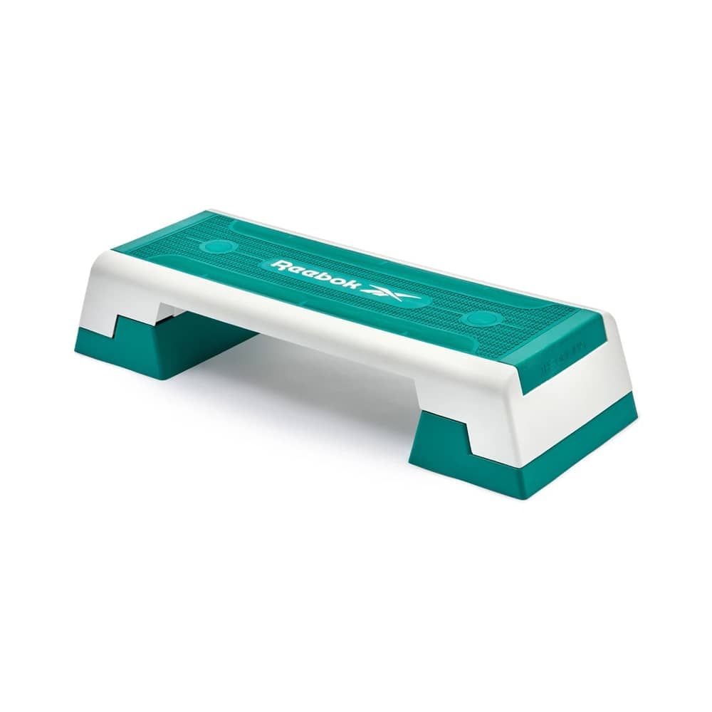 Reebok Step, teal und weiß. Rechteckige Form mit zwei Stützfüßen. Reebok Logo.