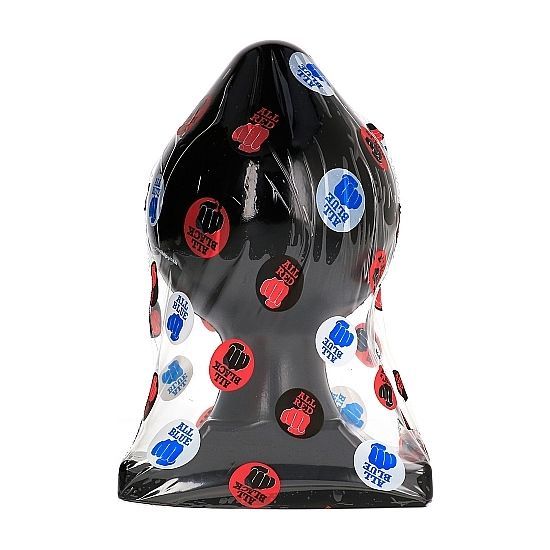 Schwarzer Analplug in Folie verpackt, bedeckt mit Aufklebern in Rot, Blau und Weiß.