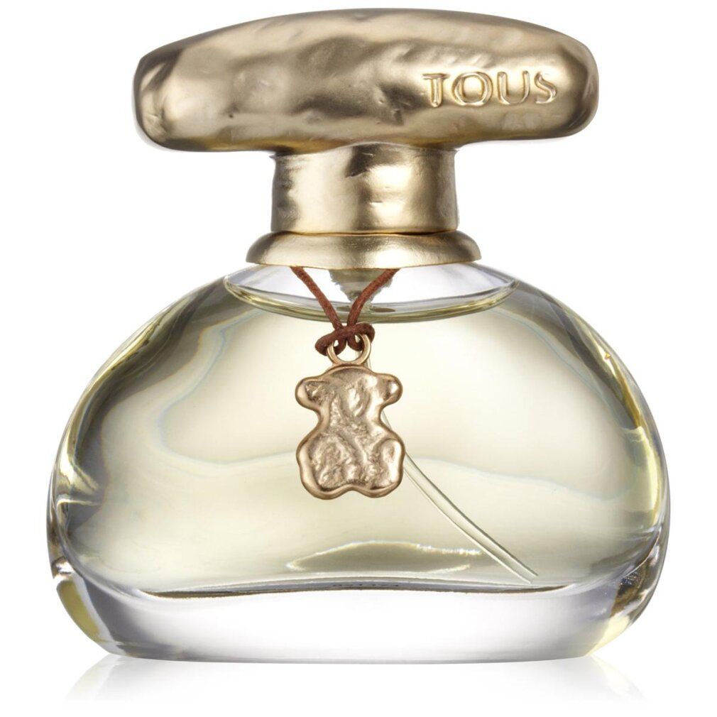 Parfümflasche mit goldfarbenem Verschluss und Anhänger. Flasche mit klarer Flüssigkeit. Anhänger in Bärenform.