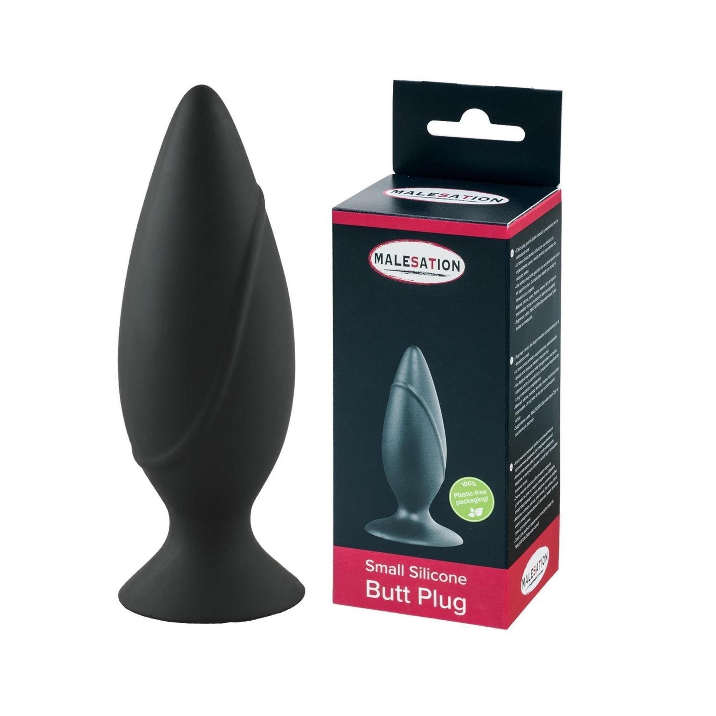 Schwarzer kleiner Silikon-Plug mit breiter Basis und gerillter Oberfläche. Verpackung daneben.