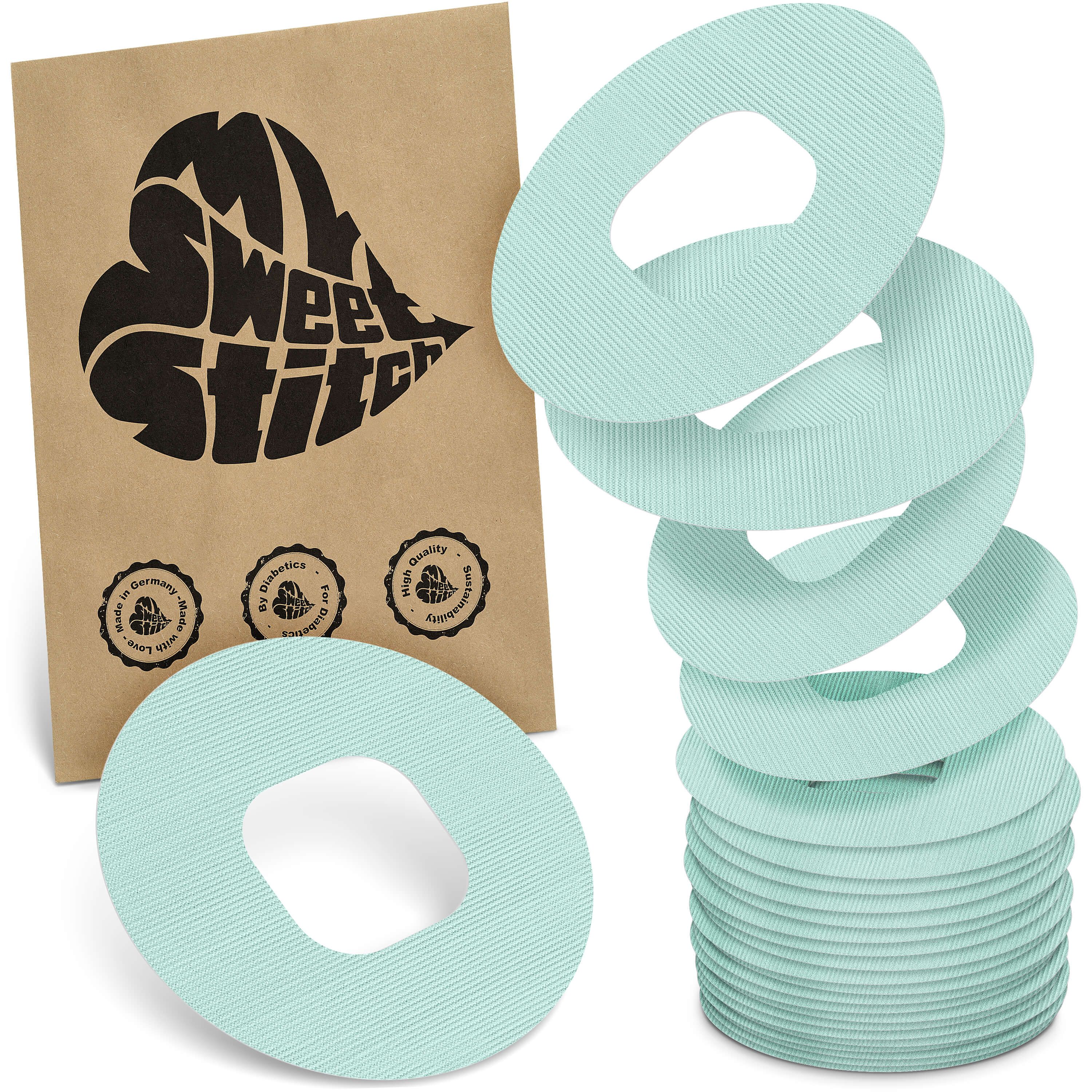 Hellgrüne, ringförmige Pflaster mit zentraler Öffnung. Verpackung mit Logo 'My Sweet Stitch'. Mehrere Pflaster gestapelt.