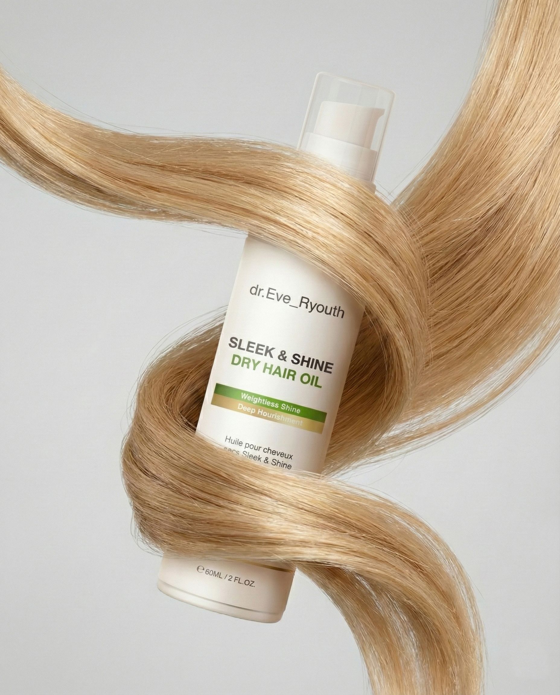 Eine Flasche Sleek & Shine Trockenöl für Haare ist von langen, blonden Haaren umgeben.