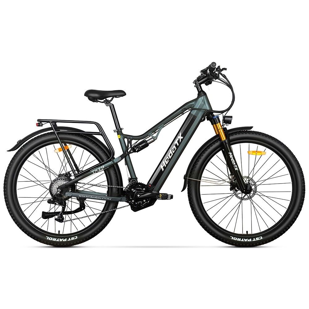 Graues E-Bike HedaTX TX19. Schwarze Reifen, Gepäckträger, Federung. Gelbe Gabel. 27 Gänge. Aufschrift HedaTX.