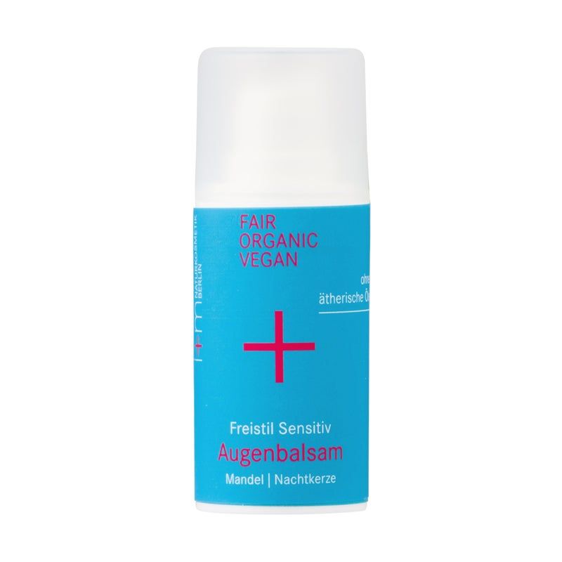 Zylinderförmige Flasche mit blauem Etikett. Aufschrift: FAIR ORGANIC VEGAN, rotes Pluszeichen, Freistil Sensitiv Augenbalsam. Deckel weiß.