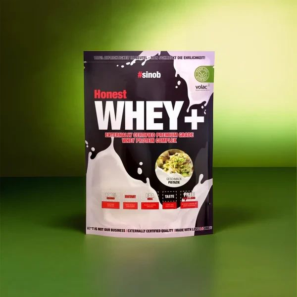 Schwarze Tüte mit weißem "Honest WHEY+"-Schriftzug. Grün-weißes Logo. "Volac"-Logo. Grün-weißer Hintergrund.