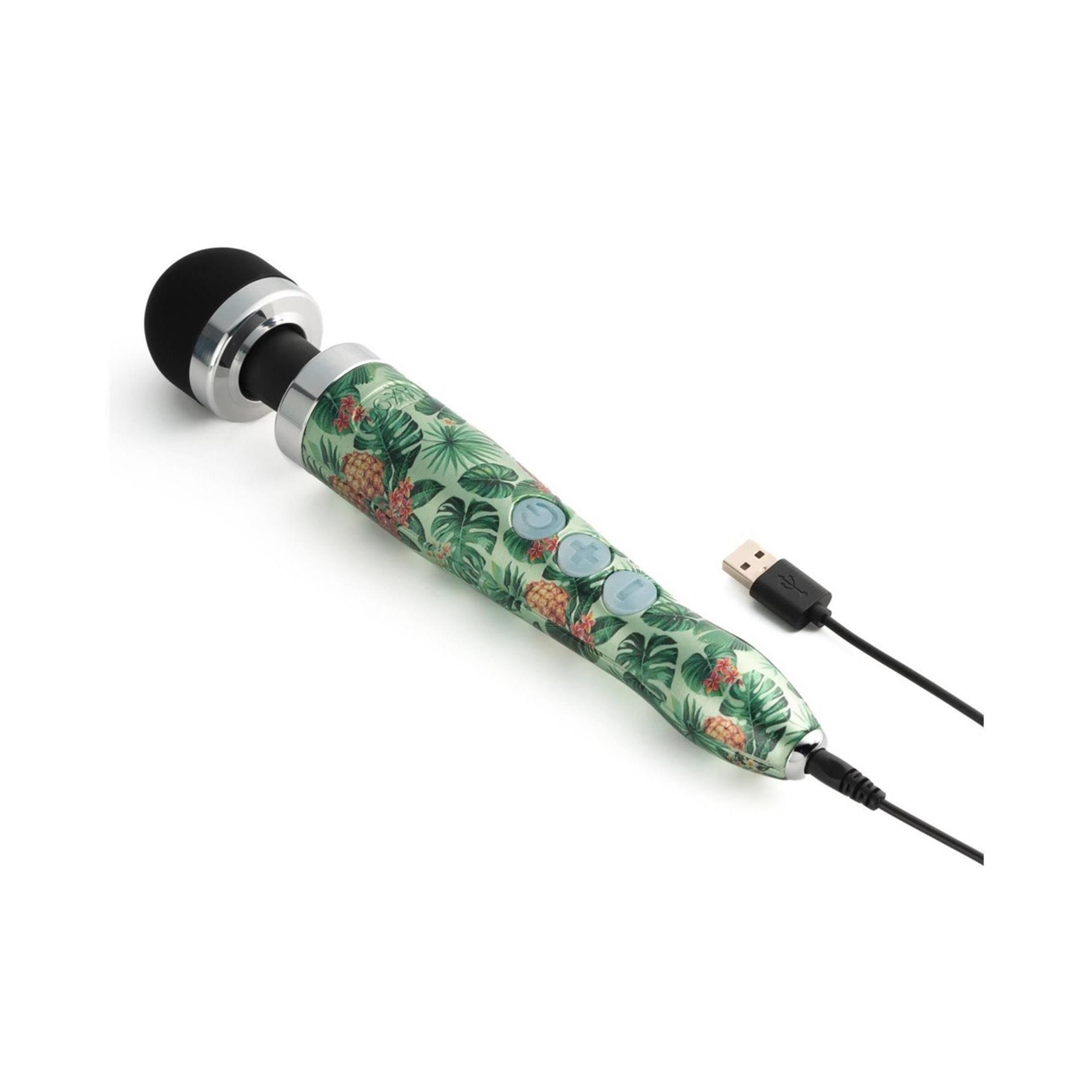 Vibrator mit schwarzem Kopf und grünem Griff mit Ananas- und Blättermuster. Drei Knöpfe. USB-Kabel.